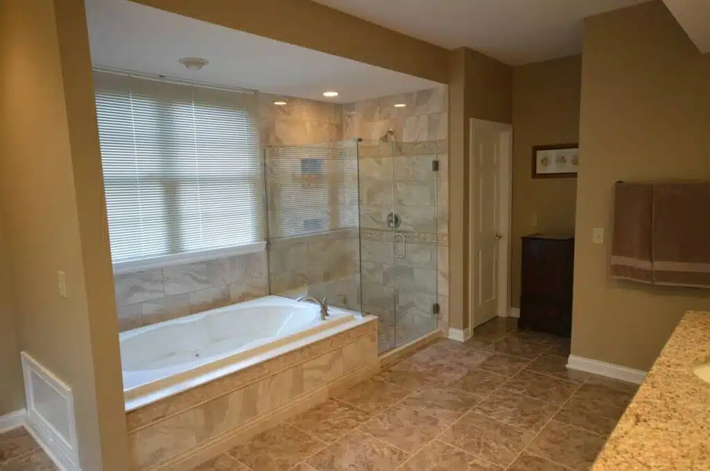 Fully tiled bathroom remodel project with a bathtub and shower combination.