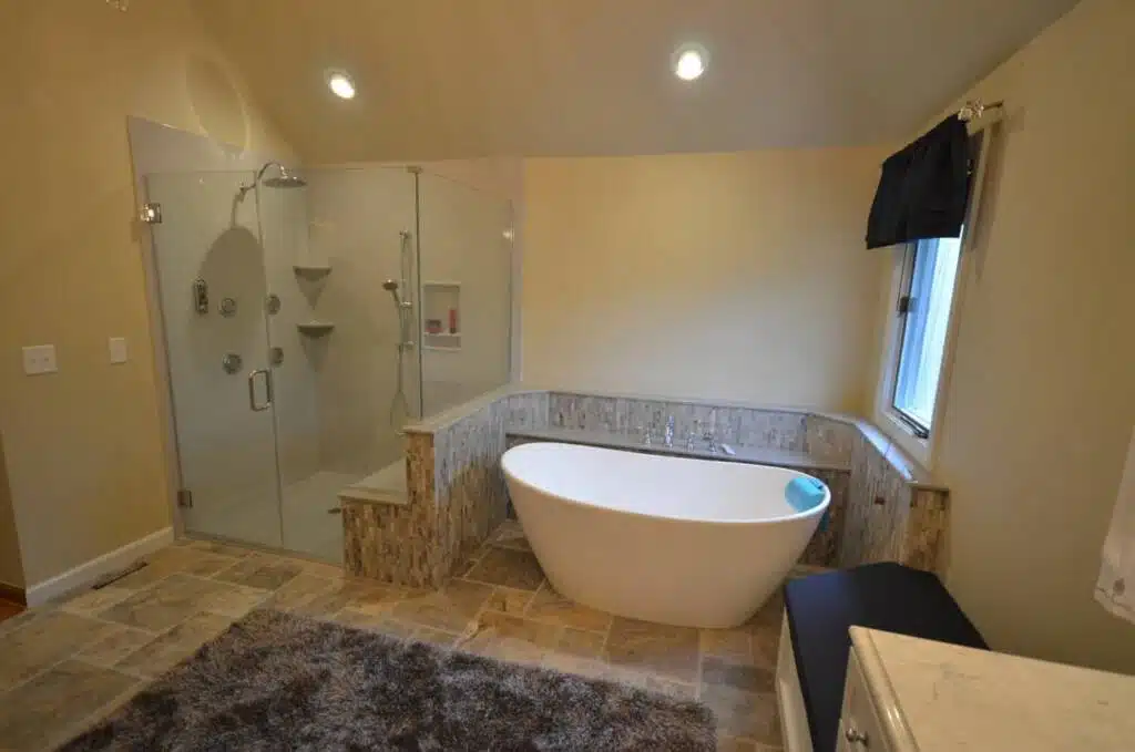 Sloped oval tub and all-glass shower combination by Columbus Bath Design in Lewis Center, Ohio.