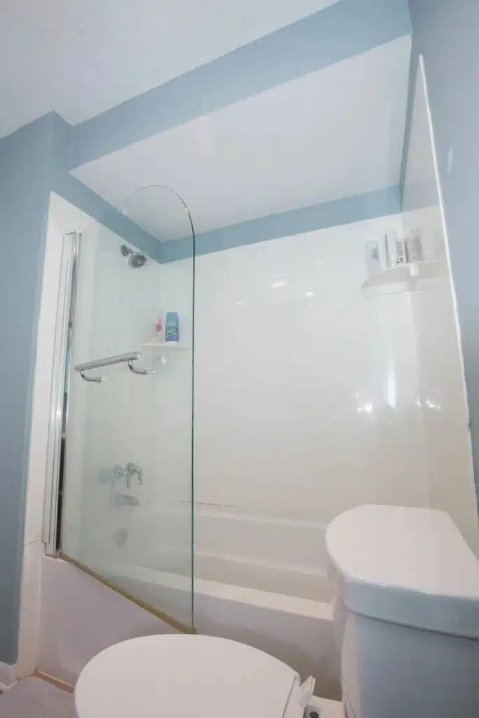Glass door tub to shower conversion with built-in bench.