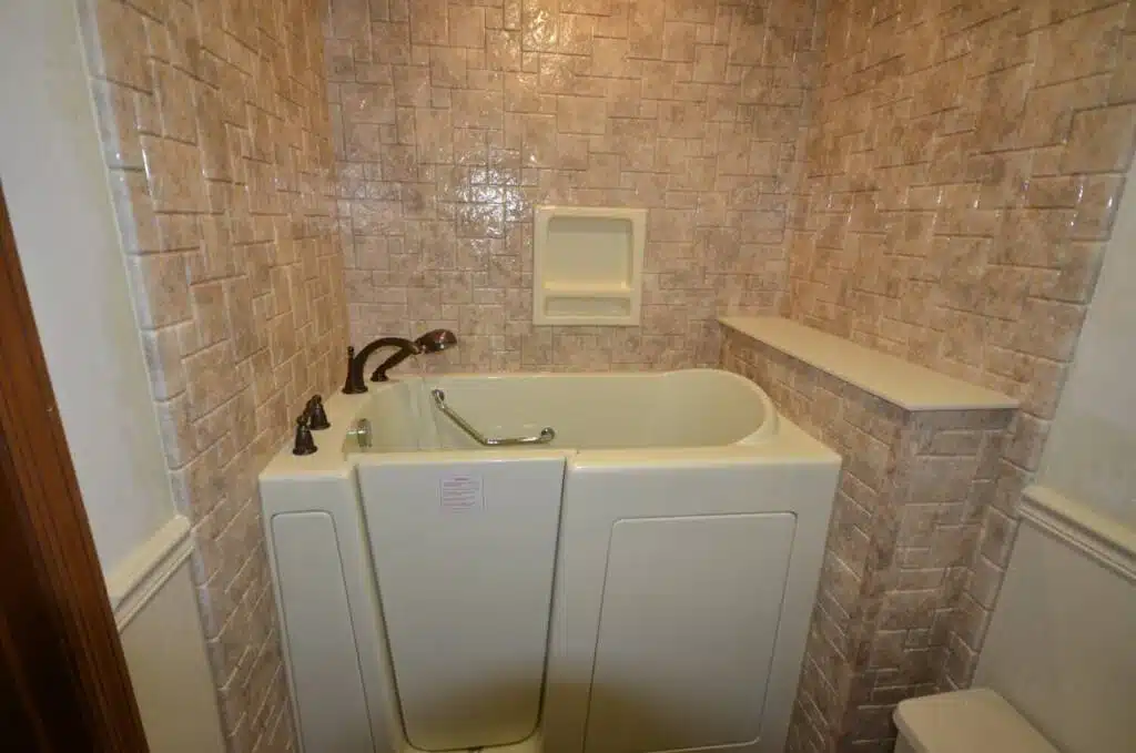 Modern bathroom tiled walls and walk-in bathtub.