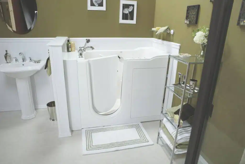 Accessible walk-in bathtub with a green and white carpet and green painted walls.