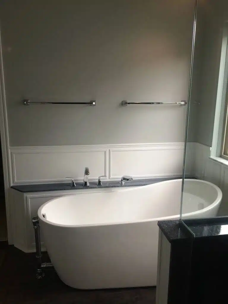 Sloped oval bathtub in a beautiful and modern bathroom remodeling project.