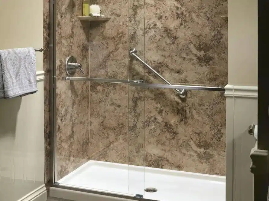 Warm brown tiled shower in bathroom with wooden floors.