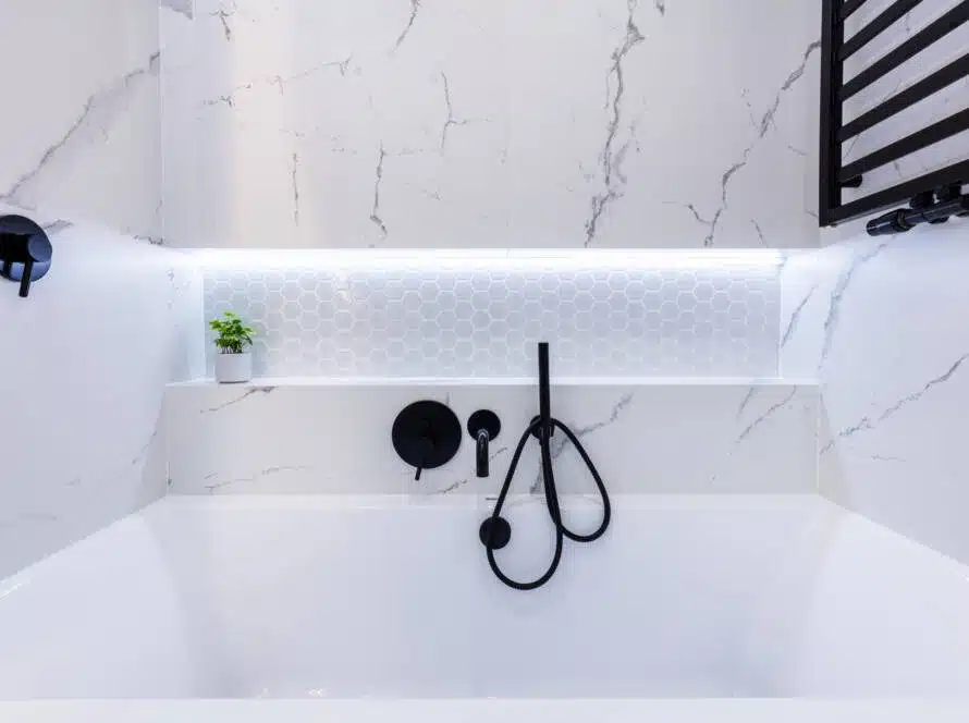 A modern bathroom design with a smart handheld faucet and white honeycomb tile.