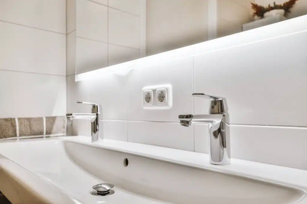 A smart sink with LED light-up mirror and chrome faucets.